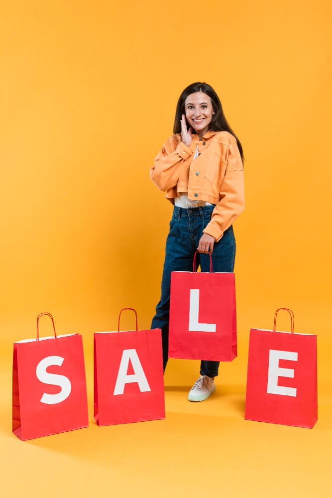 front-view-happy-woman-posing-with-sale-shopping-bags